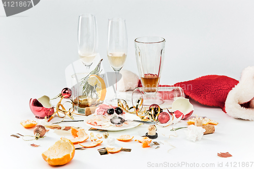 Image of The morning after christmas day, table with alcohol and leftovers