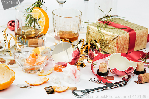 Image of The morning after christmas day, table with alcohol and leftovers