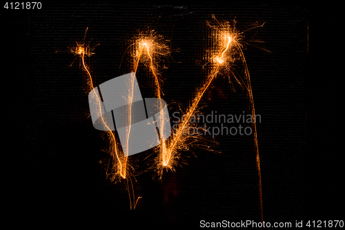 Image of Letter W made of sparklers on black