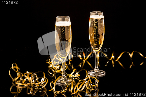 Image of Glasses with champagne against holiday lights