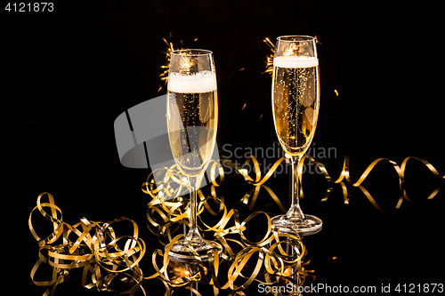 Image of Glasses with champagne against holiday lights