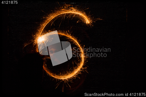 Image of Number 6 made of sparklers on black