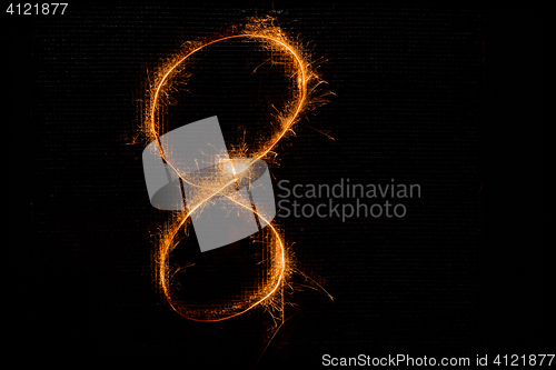 Image of Number 8 made of sparklers on black