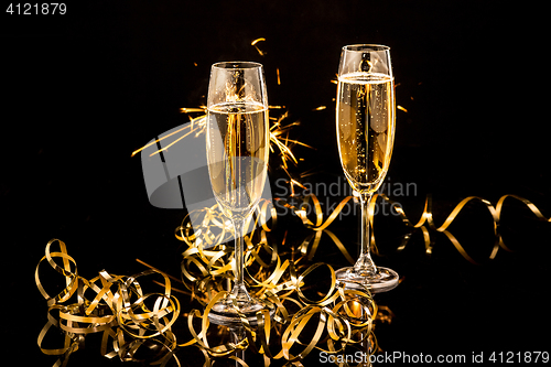 Image of Glasses with champagne against holiday lights