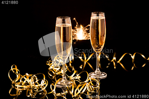 Image of Glasses with champagne against holiday lights