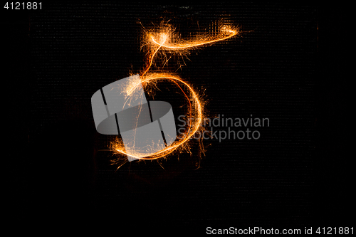 Image of Number 5 made of sparklers on black