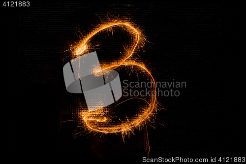 Image of Number 3 made of sparklers on black