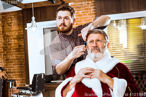 Image of Santa claus shaving his personal barber