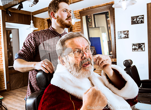 Image of Santa claus shaving his personal barber