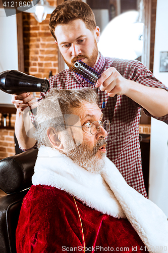 Image of Santa claus shaving his personal barber