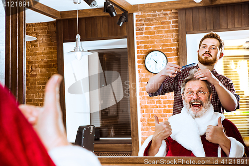 Image of Santa claus shaving his personal barber