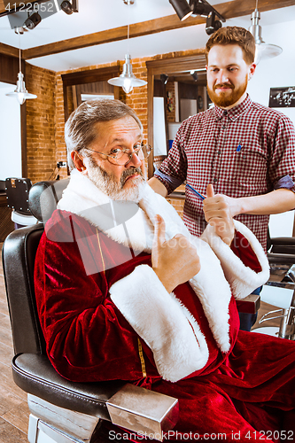 Image of Santa claus shaving his personal barber