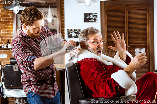 Image of Santa claus shaving his personal barber