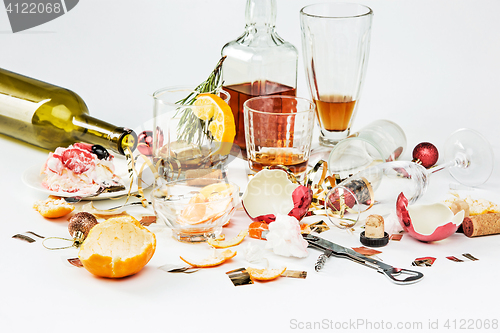 Image of The morning after christmas day, table with alcohol and leftovers