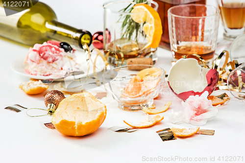 Image of The morning after christmas day, table with alcohol and leftovers