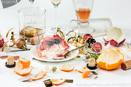 Image of The morning after christmas day, table with alcohol and leftovers