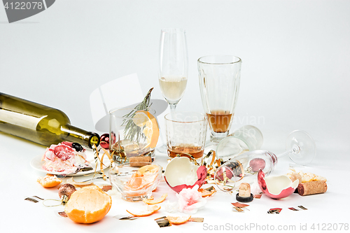 Image of The morning after christmas day, table with alcohol and leftovers