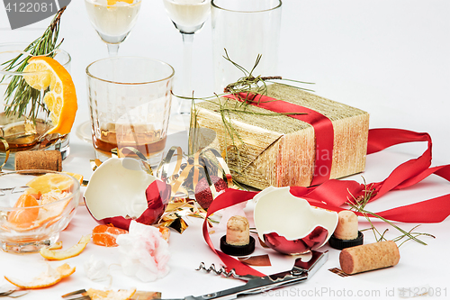 Image of The morning after christmas day, table with alcohol and leftovers