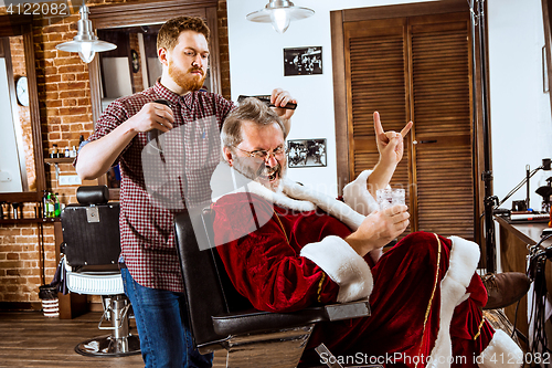 Image of Santa claus shaving his personal barber