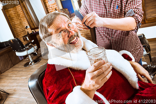 Image of Santa claus shaving his personal barber