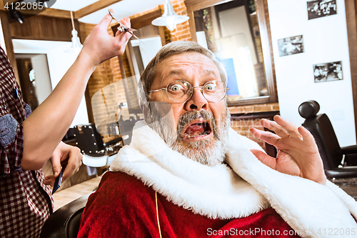 Image of Santa claus shaving his personal barber