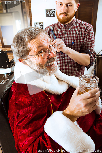 Image of Santa claus shaving his personal barber