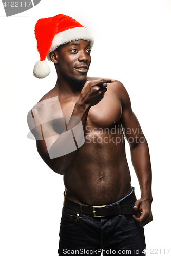 Image of Muscular black shirtless young man in Santa Claus hat