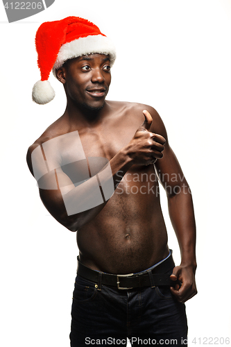 Image of Muscular black shirtless young man in Santa Claus hat