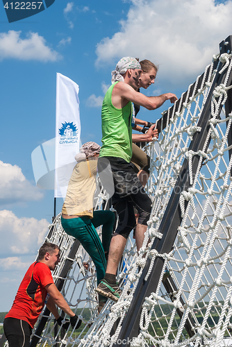 Image of Team storms net wall in extrim race. Tyumen.Russia