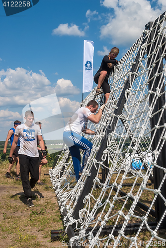 Image of Team storms net wall in extrim race. Tyumen.Russia