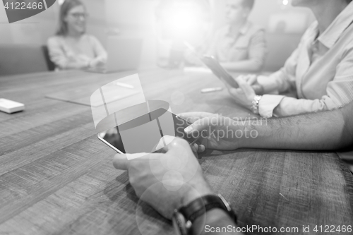 Image of close up of businessman on meeting using tablet