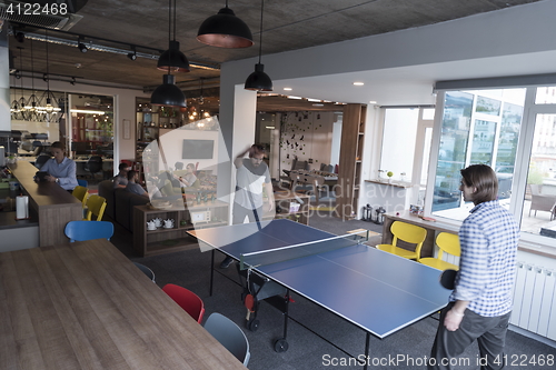 Image of playing ping pong tennis at creative office space