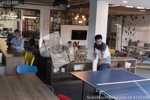 Image of playing ping pong tennis at creative office space