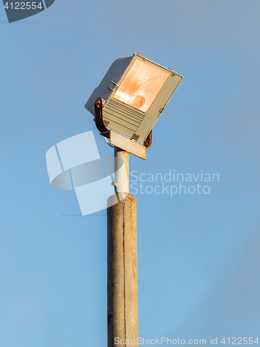 Image of Security light against blue sky 