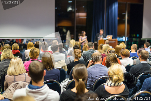 Image of Audience in lecture hall participating at business conference.