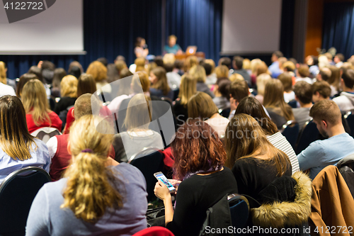 Image of Audience in lecture hall participating at business conference.