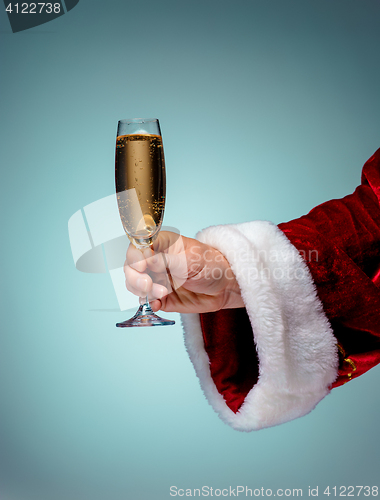 Image of Santa Holding Champagne wineglass over blue