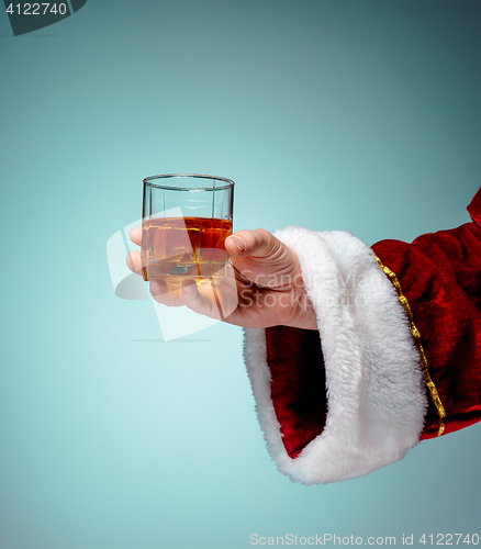 Image of Santa Holding with a beer glass over blue