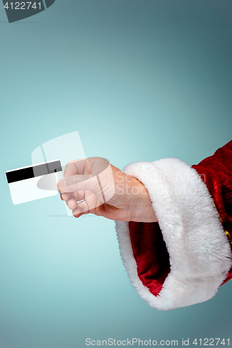 Image of Santa Claus hand holding a credit card