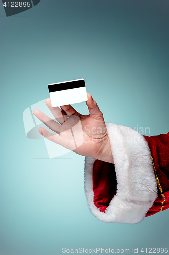 Image of Santa Claus hand holding a credit card