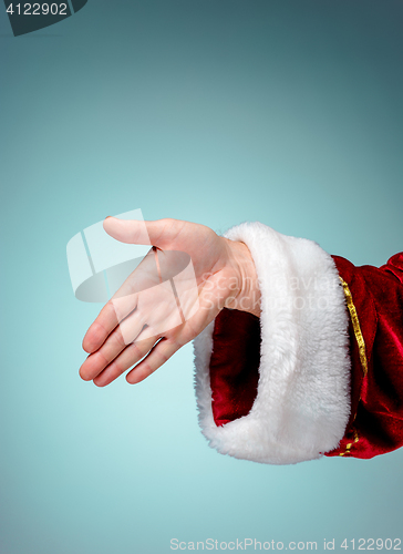 Image of Photo of Santa Claus hand in gesture of a handshake