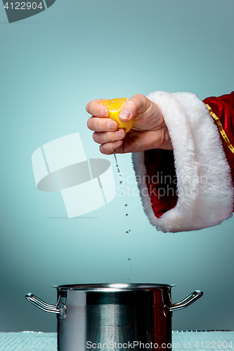 Image of Photo of Santa Claus hand squeezing lemon