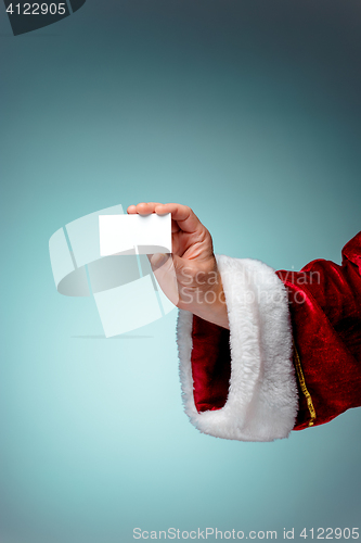 Image of Photo of Santa Claus hand with a business card