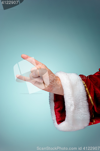 Image of Photo of Santa Claus hand in rocker gesture