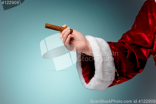 Image of Photo of Santa Claus hand with a cigar