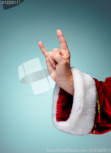 Image of Photo of Santa Claus hand in rocker gesture