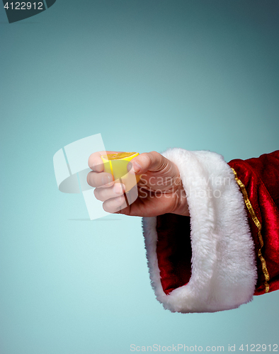 Image of Photo of Santa Claus hand squeezing lemon