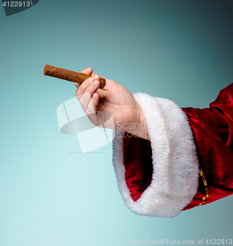 Image of Photo of Santa Claus hand with a cigar