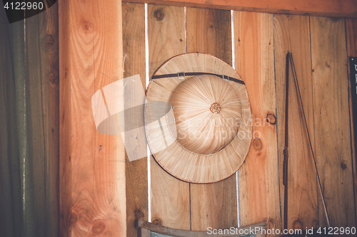 Image of Tropical hat hanging on a wooden wall