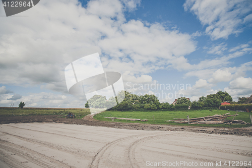 Image of Large rural yard with tracks in sand